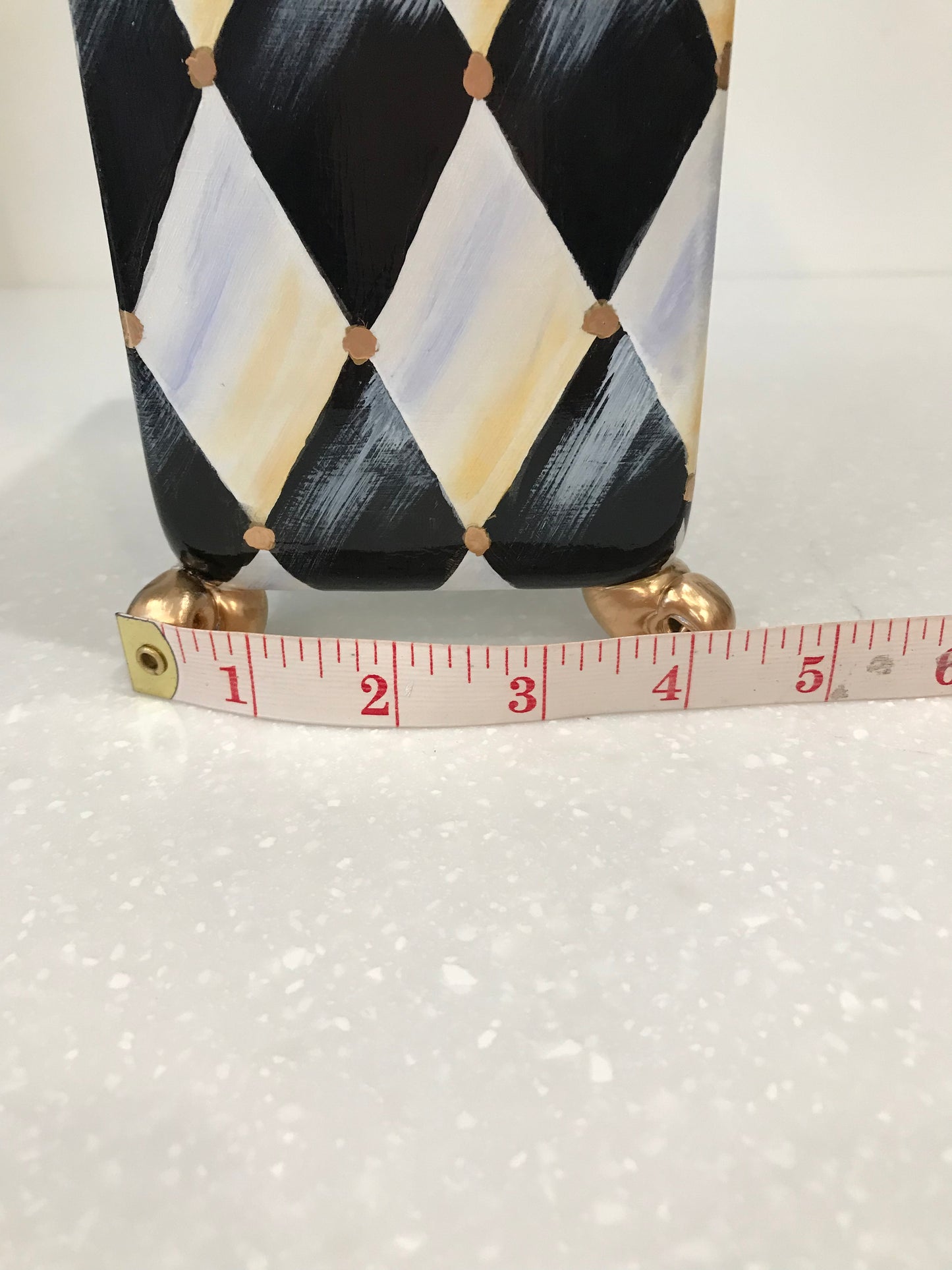 Whimsical harlequin vase with golden feet